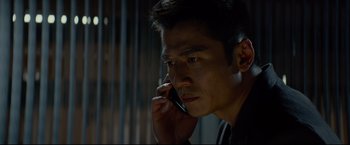 Movie still from “Man of Tai Chi” (2013), directed by Keanu Reeves – A person talking on a cell phone; Close Up shot, Low angle