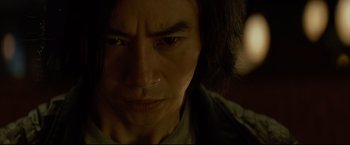 Movie still from “Man of Tai Chi” (2013), directed by Keanu Reeves – A person with long black hair; Close Up shot, Low angle