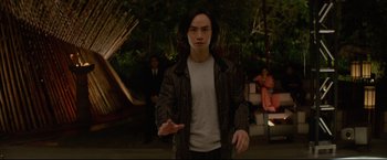 Movie still from “Man of Tai Chi” (2013), directed by Keanu Reeves – A man in a white shirt and a black jacket; Medium shot, Low angle