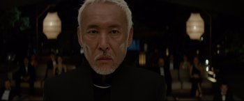 Movie still from “Man of Tai Chi” (2013), directed by Keanu Reeves – A person wearing a priest's outfit; Close Up shot, Low angle