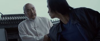 Movie still from “Man of Tai Chi” (2013), directed by Keanu Reeves – A man and a woman talking to each other; Close Up shot, Over the shoulder angle