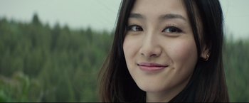 Movie still from “Man of Tai Chi” (2013), directed by Keanu Reeves – A young woman's face with long eyelashes; Close Up shot, Low angle