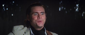 Movie still from “Man on the Moon” (1999), directed by Milos Forman – A person making a funny face; Close Up shot, Over the shoulder angle