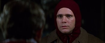 Movie still from “Man on the Moon” (1999), directed by Milos Forman – A man wearing a red hat and a brown jacket; Close Up shot, Over the shoulder angle