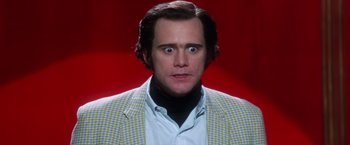 Movie still from “Man on the Moon” (1999), directed by Milos Forman – A person wearing a suit and tie; Close Up shot, Low angle