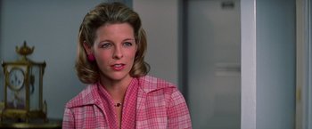 Movie still from “Man on the Moon” (1999), directed by Milos Forman – A person wearing a pink shirt; Close Up shot, Over the shoulder angle