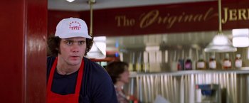 Movie still from “Man on the Moon” (1999), directed by Milos Forman – A man wearing an apron standing in front of a counter; Close Up shot, Low angle