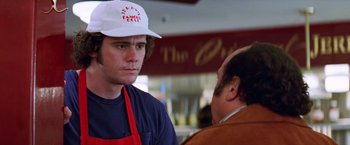 Movie still from “Man on the Moon” (1999), directed by Milos Forman – A man wearing an apron talking to another man in an apron; Close Up shot, Over the shoulder angle