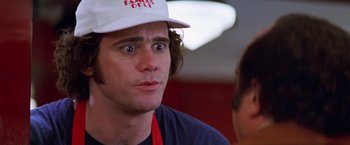 Movie still from “Man on the Moon” (1999), directed by Milos Forman – A man wearing a white hat and looking surprised; Close Up shot, Over the shoulder angle