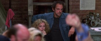 Movie still from “Man on the Moon” (1999), directed by Milos Forman – A man and a woman sitting next to each other; Medium shot, Low angle