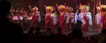 Movie still from “Man on the Moon” (1999), directed by Milos Forman – A group of women are performing on a stage; Wide shot, High angle
