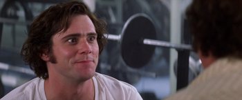 Movie still from “Man on the Moon” (1999), directed by Milos Forman – A person sitting in front of a wall; Close Up shot, Low angle