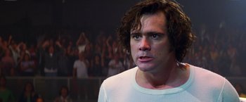 Movie still from “Man on the Moon” (1999), directed by Milos Forman – A person with a crowd in the background; Close Up shot, Low angle