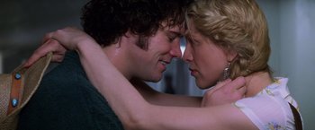 Movie still from “Man on the Moon” (1999), directed by Milos Forman – A man and a woman embracing each other; Close Up shot, Overhead angle