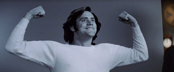 Movie still from “Man on the Moon” (1999), directed by Milos Forman – A man in a white shirt is looking up; Close Up shot, Low angle