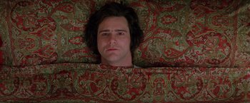 Movie still from “Man on the Moon” (1999), directed by Milos Forman – A man laying on top of a couch with his eyes wide open; Close Up shot, Overhead angle
