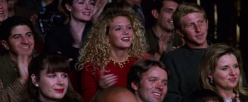 Movie still from “Man on the Moon” (1999), directed by Milos Forman – A group of people sitting and standing in a room; Close Up shot, High angle