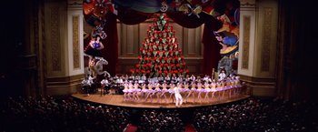 Movie still from “Man on the Moon” (1999), directed by Milos Forman – A group of people standing in front of a christmas tree on a stage; Extreme Wide shot, Low angle
