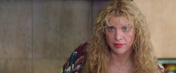 Movie still from “Man on the Moon” (1999), directed by Milos Forman – A person with long blonde hair; Close Up shot, Low angle