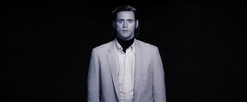 Movie still from “Man on the Moon” (1999), directed by Milos Forman – A black and white photo of a man in a suit; Close Up shot, Low angle