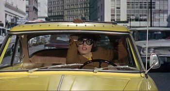 Movie still from “Man's Favorite Sport?” (1964), directed by Howard Hawks – A woman sitting in the driver's seat of a yellow car; Medium shot, Low angle