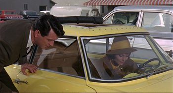Movie still from “Man's Favorite Sport?” (1964), directed by Howard Hawks – A man and a woman sitting in a yellow car; Medium shot, Over the shoulder angle