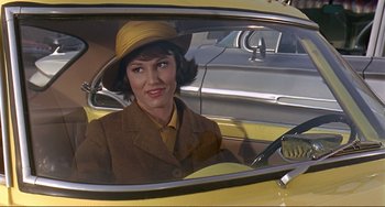 Movie still from “Man's Favorite Sport?” (1964), directed by Howard Hawks – A woman sitting in the passenger seat of a yellow car; Medium shot, Low angle