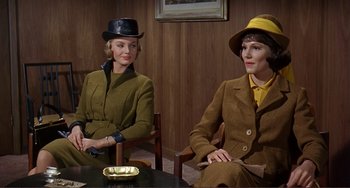 Movie still from “Man's Favorite Sport?” (1964), directed by Howard Hawks – A couple of women sitting next to each other in a room; Medium shot, Over the shoulder angle