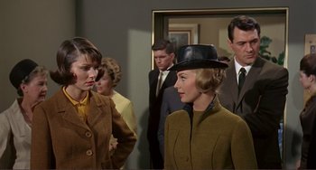 Movie still from “Man's Favorite Sport?” (1964), directed by Howard Hawks – A group of people standing in a room; Medium shot, Over the shoulder angle