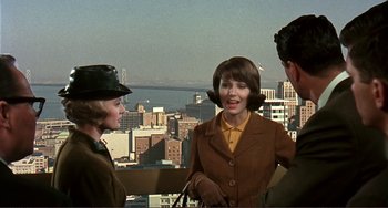 Movie still from “Man's Favorite Sport?” (1964), directed by Howard Hawks – A group of people standing on top of a tall building; Medium shot, Over the shoulder angle