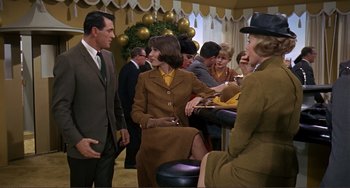 Movie still from “Man's Favorite Sport?” (1964), directed by Howard Hawks – A group of people sitting around a table; Medium shot, Over the shoulder angle