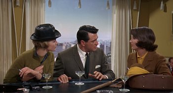 Movie still from “Man's Favorite Sport?” (1964), directed by Howard Hawks – A group of people sitting at a table with drinks; Medium shot, Over the shoulder angle