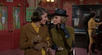Movie still from “Man's Favorite Sport?” (1964), directed by Howard Hawks – Two women are talking to each other while wearing gloves; Medium shot, Low angle