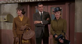 Movie still from “Man's Favorite Sport?” (1964), directed by Howard Hawks – A group of people standing next to each other in a room; Medium shot, Low angle