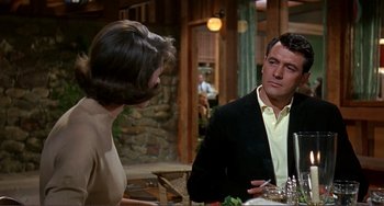 Movie still from “Man's Favorite Sport?” (1964), directed by Howard Hawks – A man and a woman sitting at a dinner table; Medium shot, Over the shoulder angle