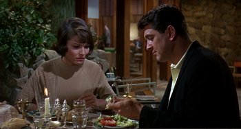 Movie still from “Man's Favorite Sport?” (1964), directed by Howard Hawks – A man and a woman sitting at a dinner table; Medium shot, Over the shoulder angle