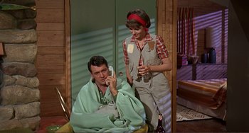 Movie still from “Man's Favorite Sport?” (1964), directed by Howard Hawks – A man and a woman are drinking wine; Medium shot, High angle