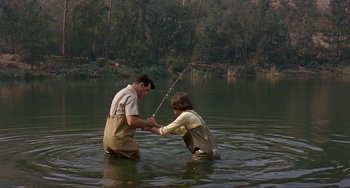 Movie still from “Man's Favorite Sport?” (1964), directed by Howard Hawks – A man and a woman fishing in a body of water; Wide shot, High angle