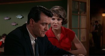 Movie still from “Man's Favorite Sport?” (1964), directed by Howard Hawks – A man and a woman sitting at a table; Medium shot, Over the shoulder angle