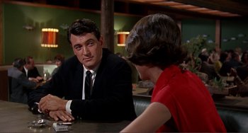 Movie still from “Man's Favorite Sport?” (1964), directed by Howard Hawks – A man and a woman sitting at a table in a restaurant; Medium shot, Over the shoulder angle