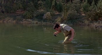 Movie still from “Man's Favorite Sport?” (1964), directed by Howard Hawks – A man fishing in a body of water; Wide shot, High angle