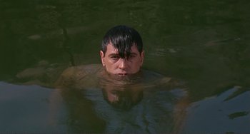 Movie still from “Man's Favorite Sport?” (1964), directed by Howard Hawks – A man in a body of water with his head above the water; Close Up shot, High angle