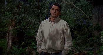 Movie still from “Man's Favorite Sport?” (1964), directed by Howard Hawks – A man standing in front of some trees; Medium shot, Over the shoulder angle