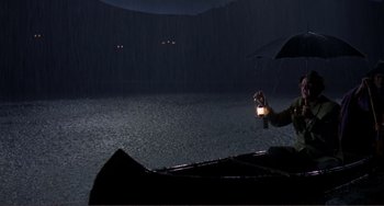 Movie still from “Man's Favorite Sport?” (1964), directed by Howard Hawks – A person holding an umbrella in the rain; Extreme Wide shot, High angle