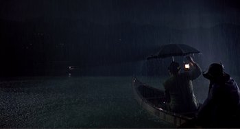 Movie still from “Man's Favorite Sport?” (1964), directed by Howard Hawks – A person in a boat in the water with an umbrella; Extreme Wide shot, High angle