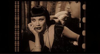 Movie still from “Man's Favorite Sport?” (1964), directed by Howard Hawks – A woman in a black and white photo holding her hand up to her face; Close Up shot, High angle