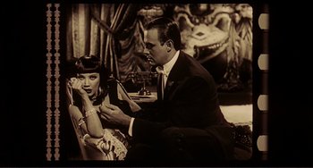 Movie still from “Man's Favorite Sport?” (1964), directed by Howard Hawks – A man and a woman sitting next to each other in a room; Medium shot, High angle