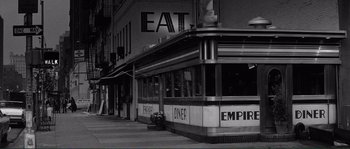 Movie still from “Manhattan” (1979), directed by Woody Allen – A black and white photo of an empire diner; Wide shot, Low angle