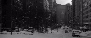 Movie still from “Manhattan” (1979), directed by Woody Allen – A city street with a lot of snow on the ground; Extreme Wide shot, High angle