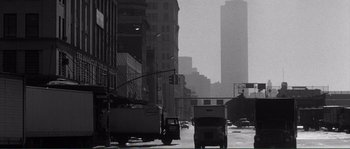 Movie still from “Manhattan” (1979), directed by Woody Allen – A black - and - white photo of a city street; Extreme Wide shot, Low angle